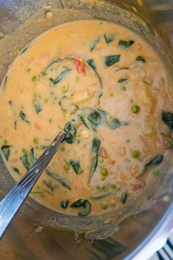 potato and spinach curry soup in a pot
