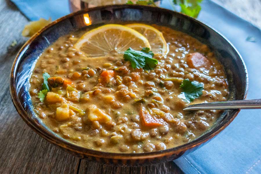 somali lentil stew in a bowl with lemon slices