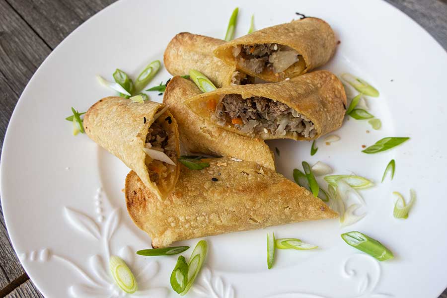 halved baked egg rolls, on a plate, gluten free