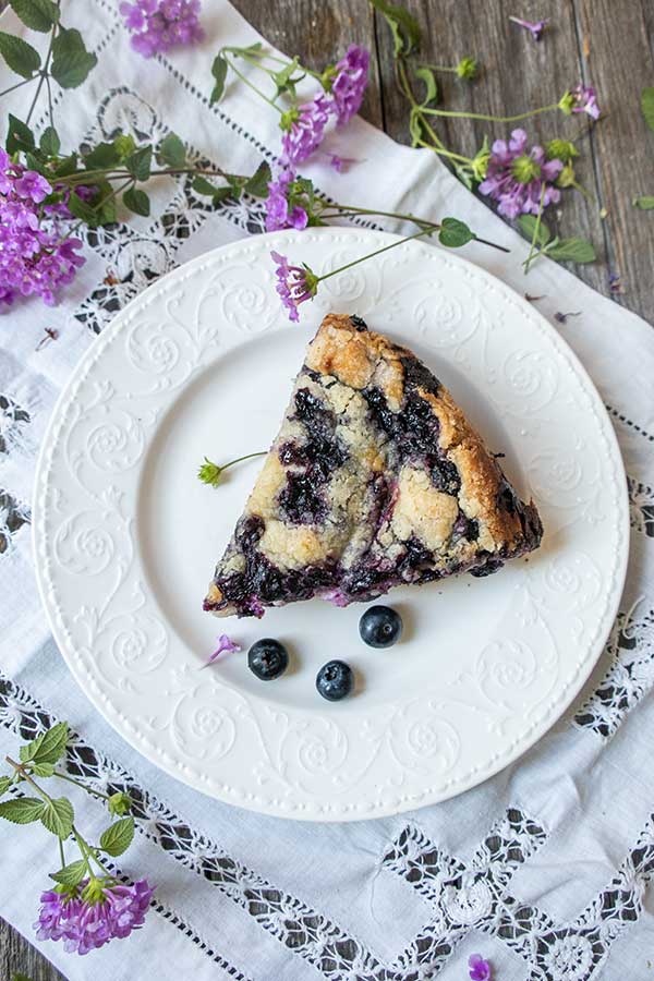 a slice of Gluten-Free Blueberry Cream Cheese Coffee Cake on a white plate