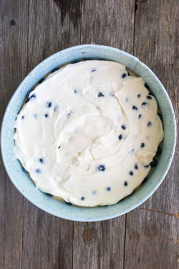 cream cheese with blueberries in a pan before baking