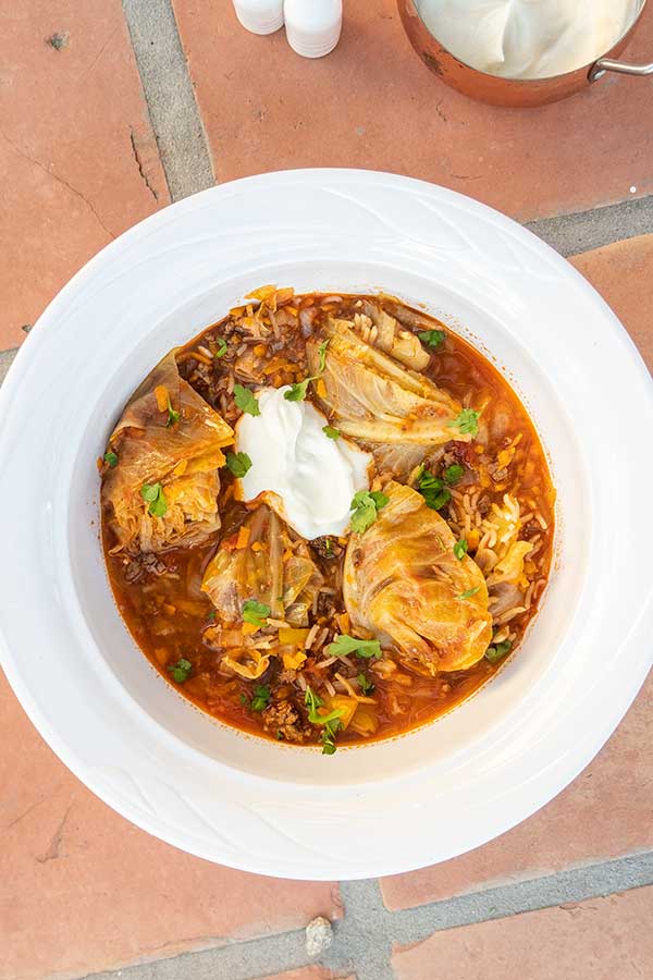 cabbage roll soup in a bowl topped with yogurt