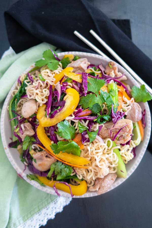 chicken ramen noodle salad with gluten-free salad dressing in a bowl with chopsticks