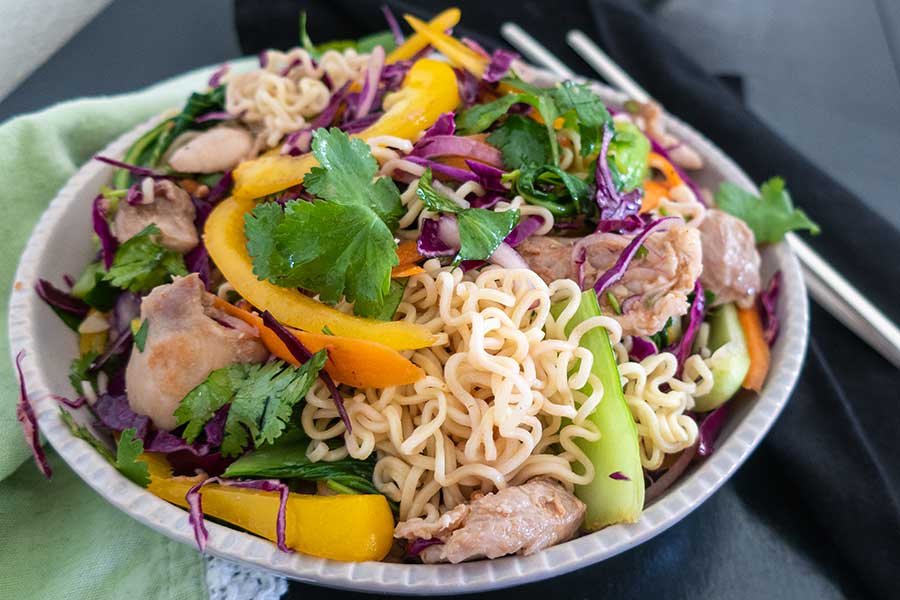 ramen noodle salad in a bowl with chop sticks