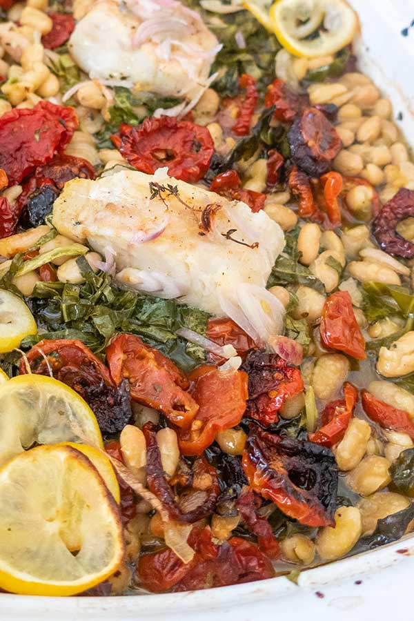 roast fish with cannellini beans, sun dried tomatoes and greens