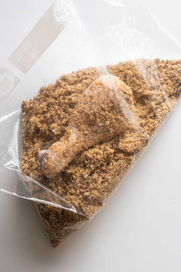 chicken piece in a plastic bag with bread crumbs