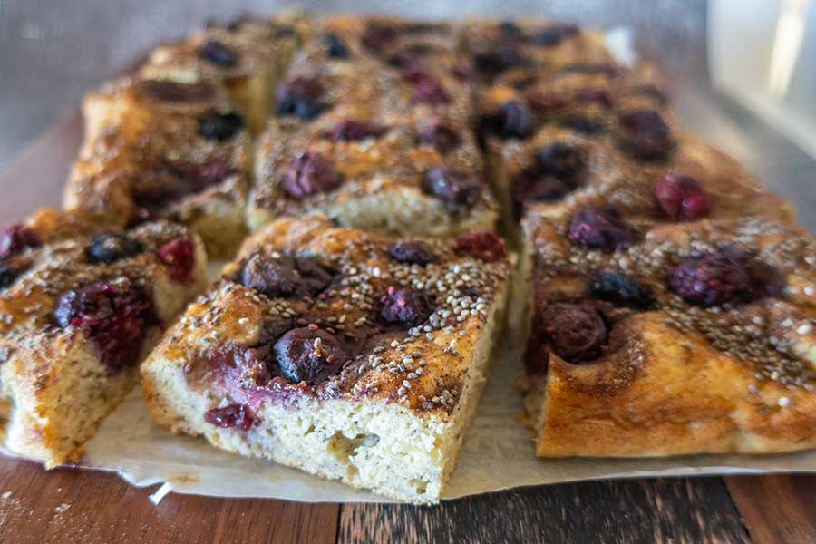 sliced banana breakfast cake with berries