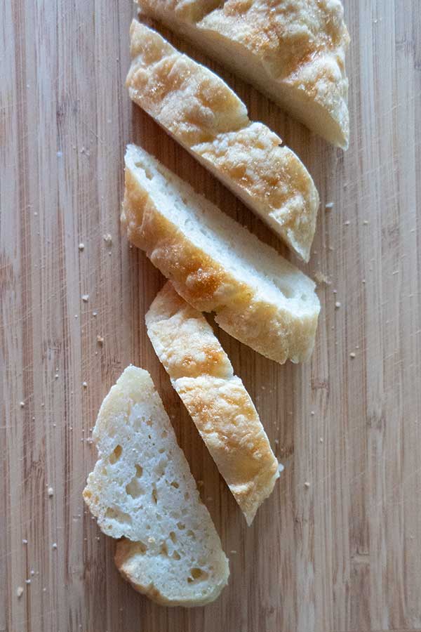 sliced gluten free Italian bread on a cutting board