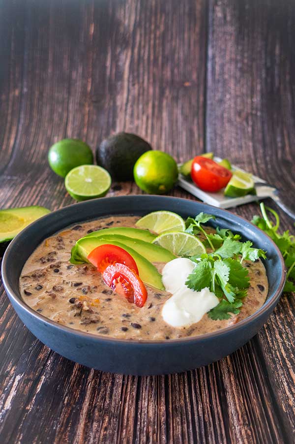 tex mex soup topped with avocado, tomatoes and sour cream.