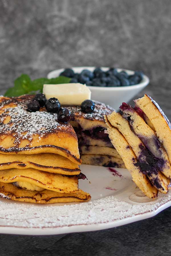 stack of coconut flour pancakes and fresh blueberries.