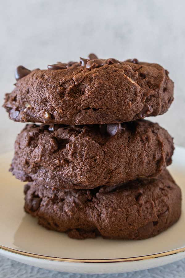 3 stacked fudgy brownie cookies on a plate