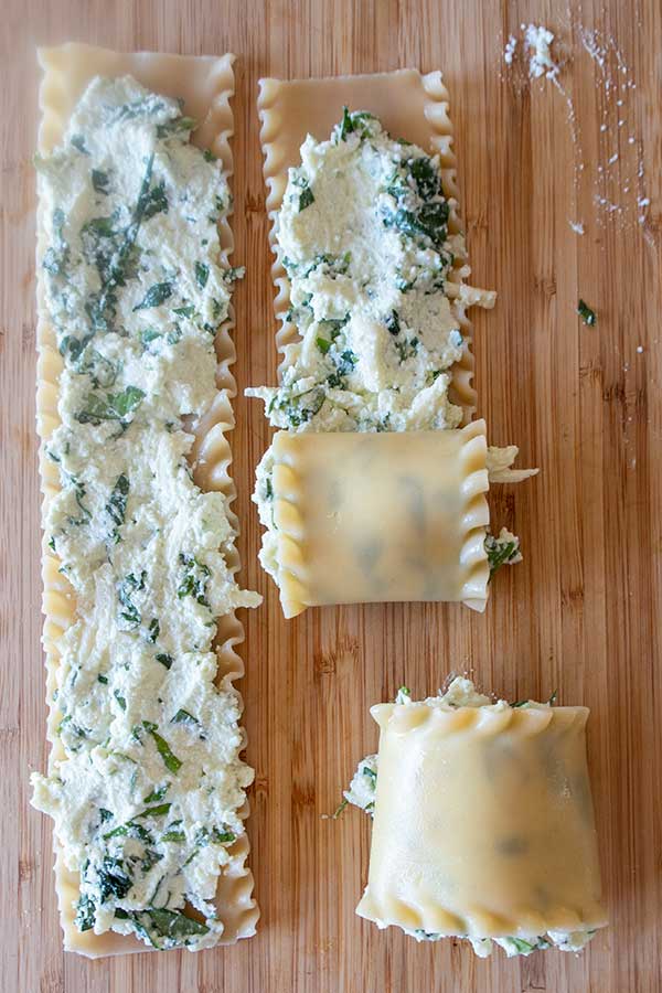 showing how to spread cheese mixture onto lasagna noodles and rolling them