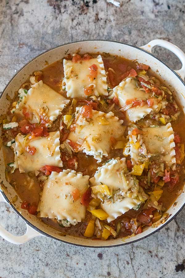 overview of cheese lasagna roll ups in a skillet before baking