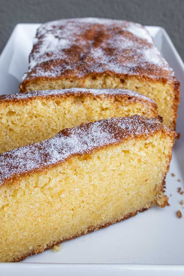 sliced rice flour pound cake sprinkled with sugar on a plate