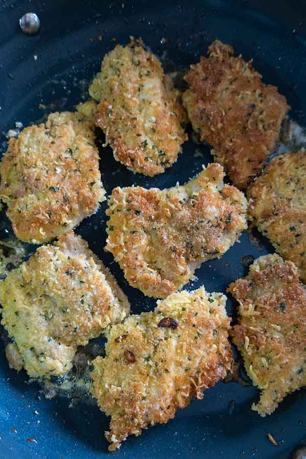 parmesan crusted chicken cooking in a pan, gluten free