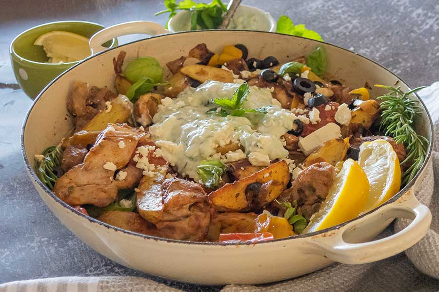 greek chicken with veggies made in a cast iron skillet