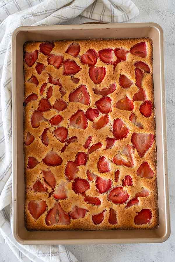 overview of baked strawberry sheet cake in a baking pan