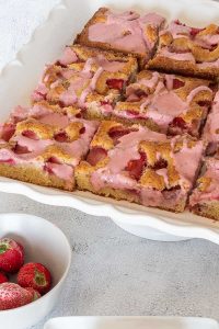 sliced gluten-free strawberry sheet cake on a platter