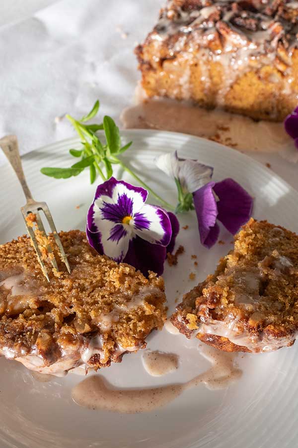 slices of apple fritter bread on a plate with a flower