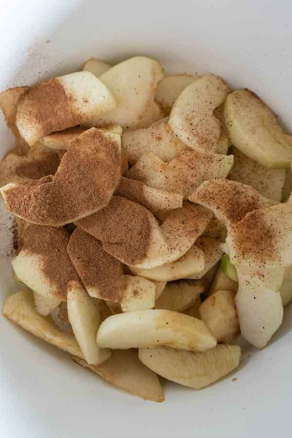 sliced apples and cinnamon in a bowl