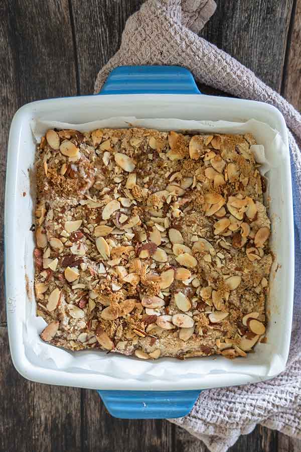 unsliced baked apple pie bars in a square baking dish