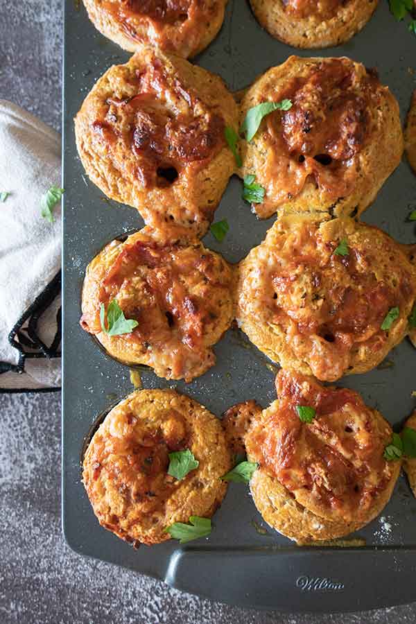 overview of baked gluten free pizza rolls on a baking sheet