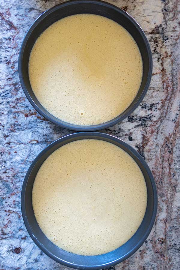 Two 8-inch round cake pans filled with cake batte