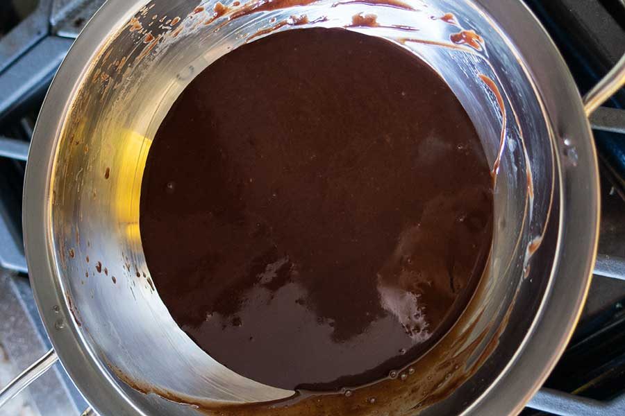 chocolate ganache glaze in a saucepan
