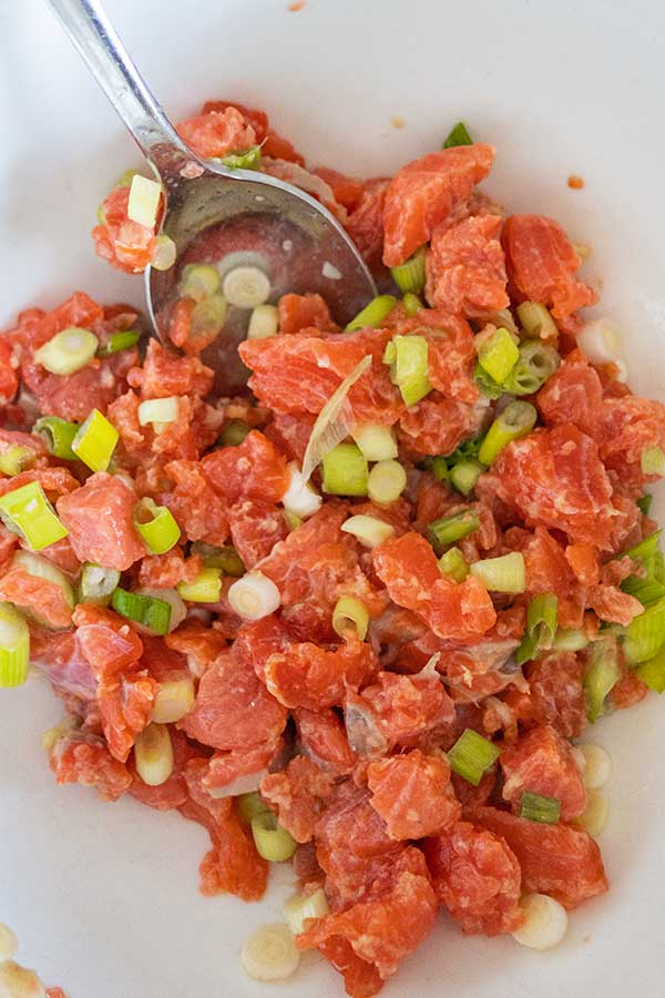 marinated salmon with sliced green onions mixture