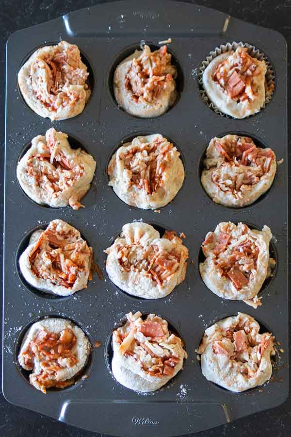 unbaked gluten-free pizza rolls in a muffin pan