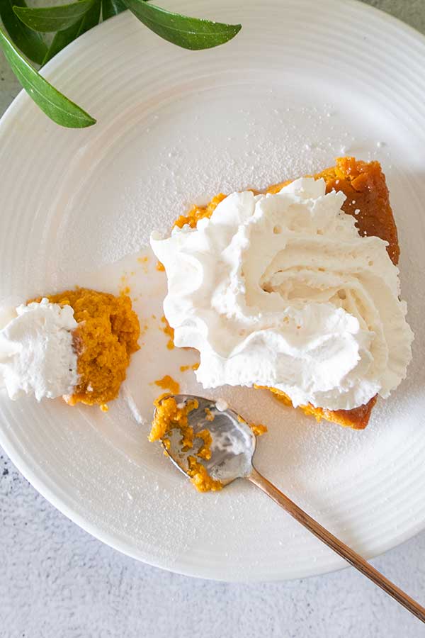 slice of pie on a plate topped with whipped cream