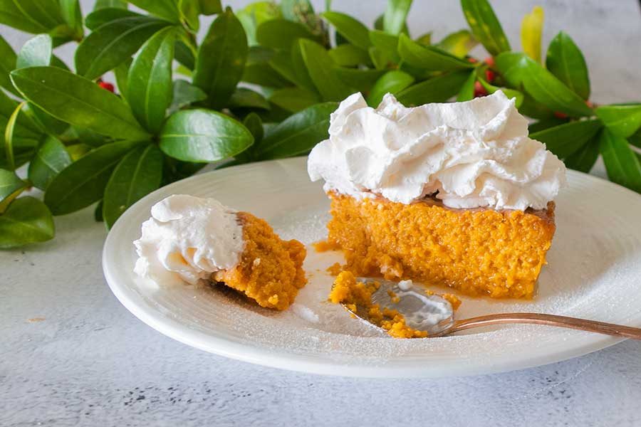 sweet potato pie with whipped cream on a plate