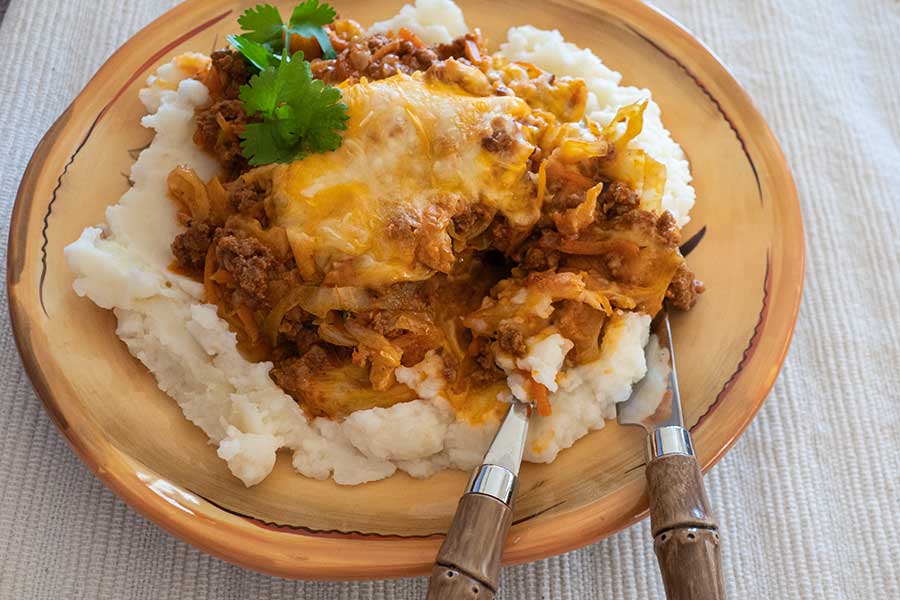 a serving of cheesy cabbage chorizo casserole on a plate