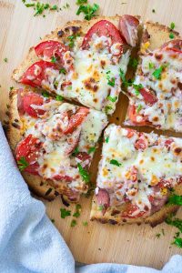 sliced keto pizza on a cutting board