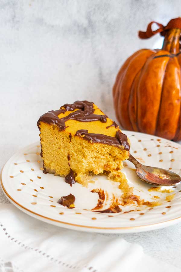 a slice of pumpkin mousse cake on a plate with a spoon