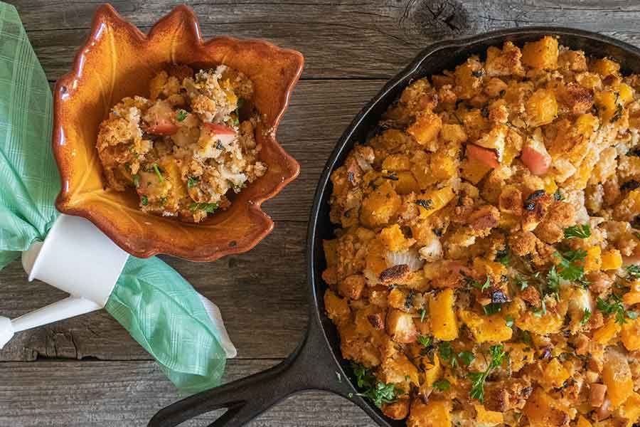 apple butternut squash stuffing in a small bowl and a skillet