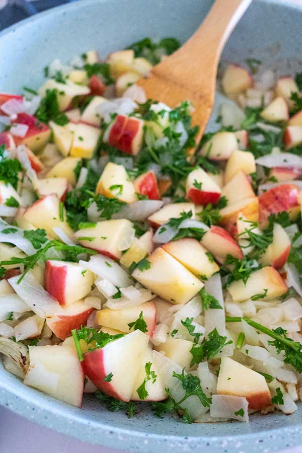 sliced apples and onions in a skillet