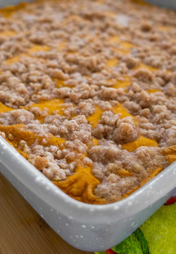 baked pumpkin cheesecake crumb bars in a pan