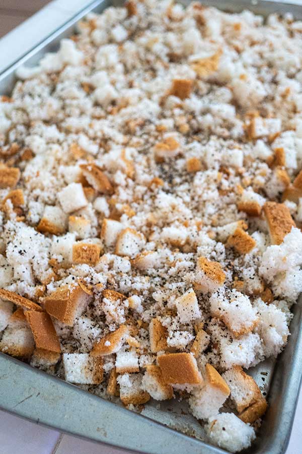 seasoned bread cubes on a baking tray