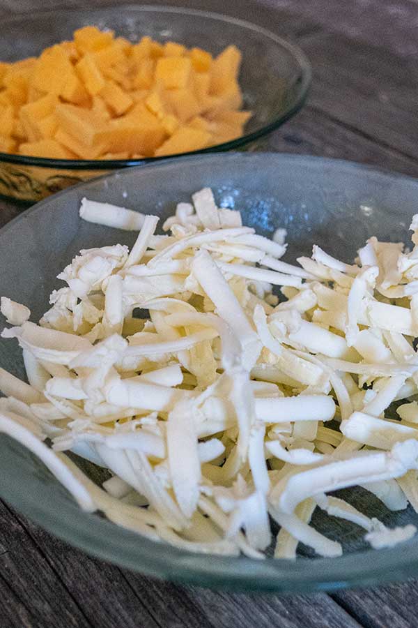 grated butter and cubed cheddar in bowls