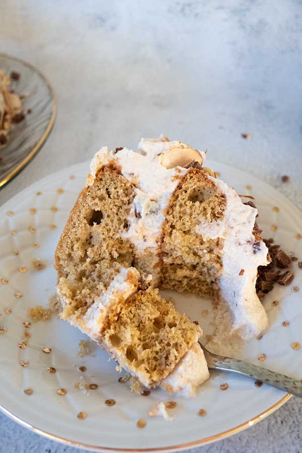 slice of cannoli cake on a plate with a spoon