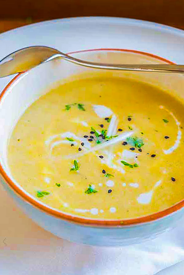 bowl of celeriac soup topped with cream and sesame seeds