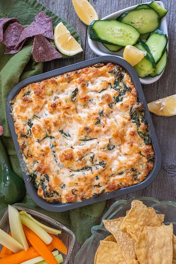 hot salmon dip with a side of veggies and corn chips