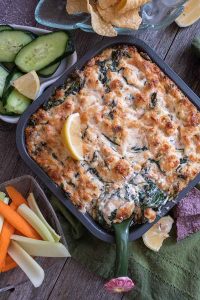 hot salmon dip in a pan with chips and veggies