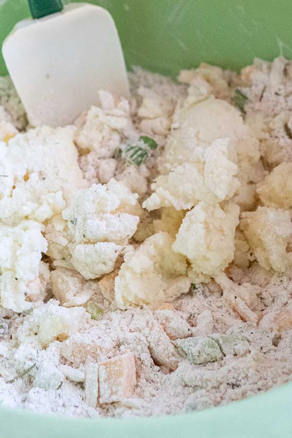 mashed potato with a flour mixture in a bowl