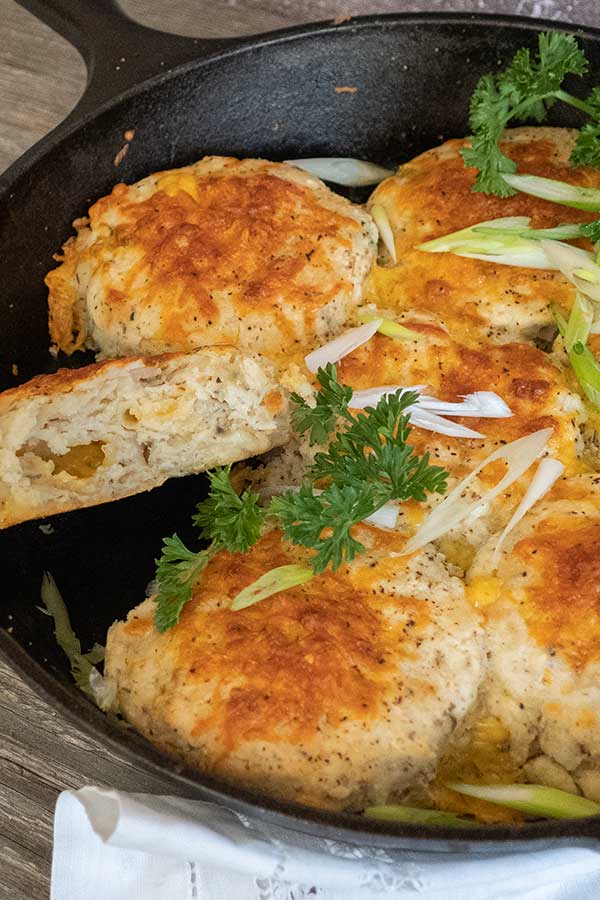 sliced gluten free mashed potato biscuit over a skillet