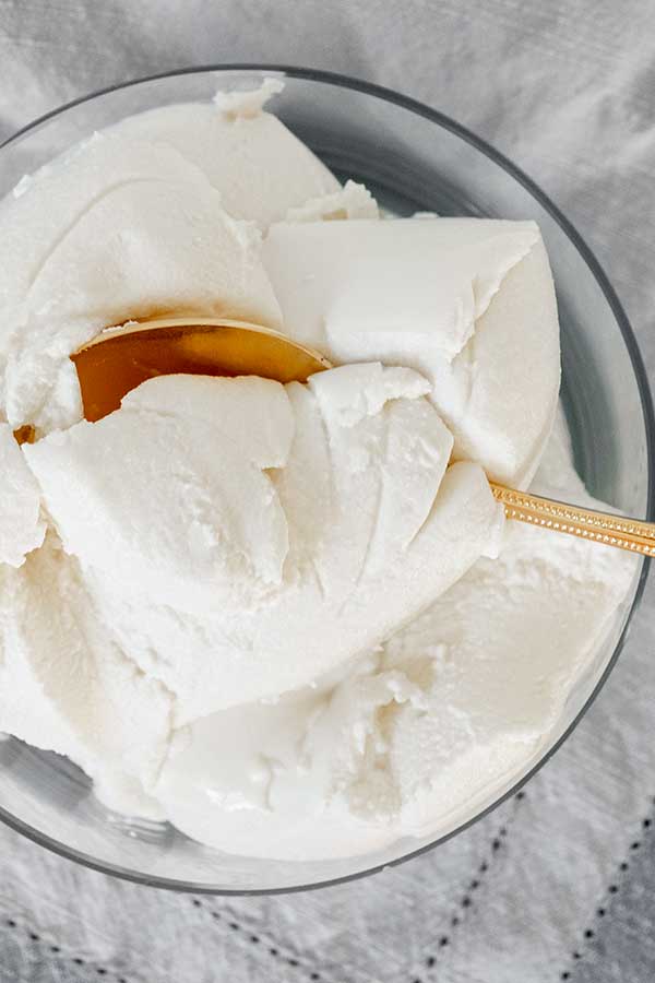 ricotta cheese in a glass bowl with a spoon