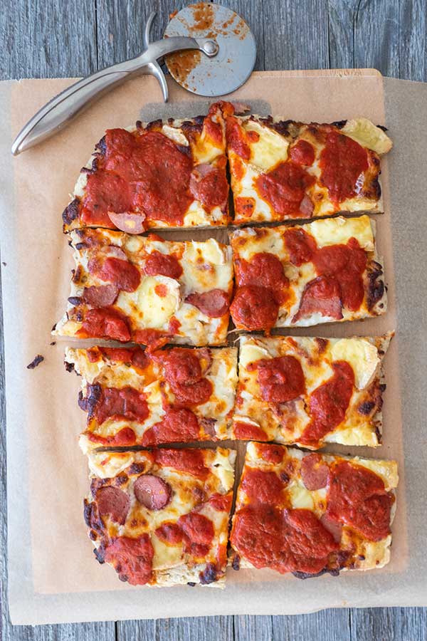 gluten free slice of detroit style pizza with pizza cutter