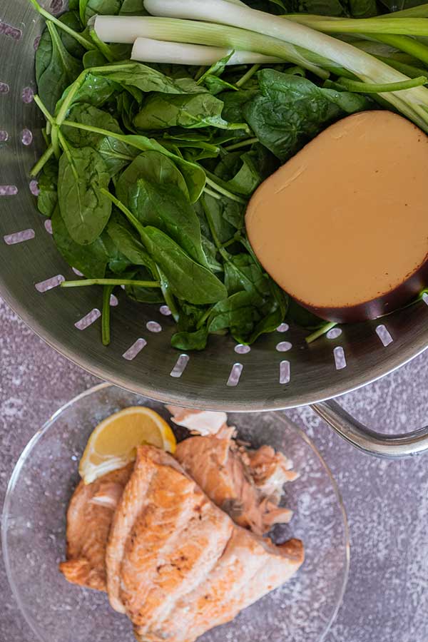 spimach, cheese, green onions, salmon in colander