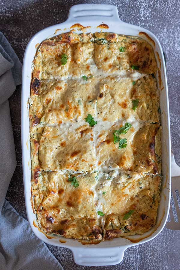 overview of baked white spinach lasagna in a lasagna dish